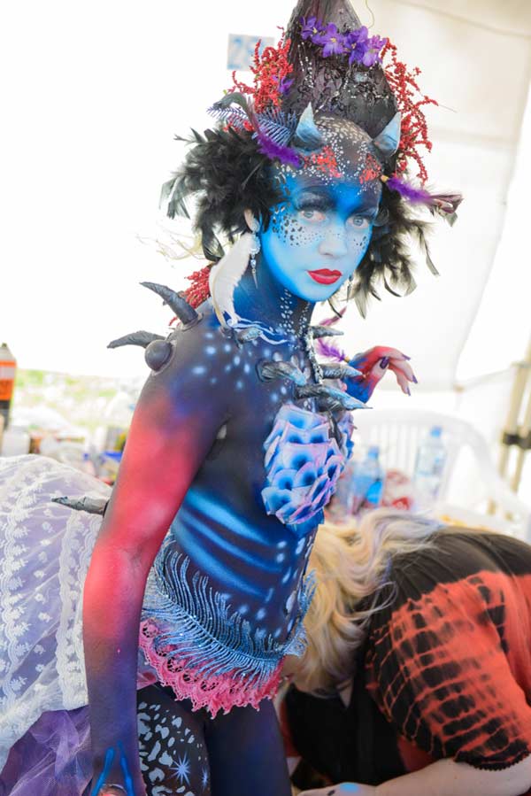 a beautiful body painting model with a blue armour painted on